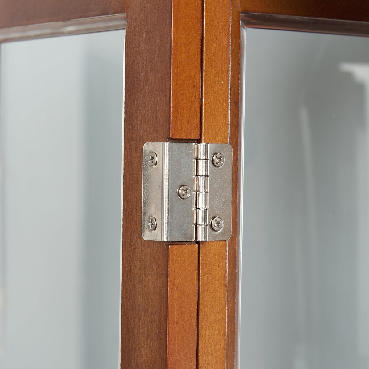 Walnut finish lighted curio cabinet with mirrored back, showcasing glass shelves and display space for collectibles.