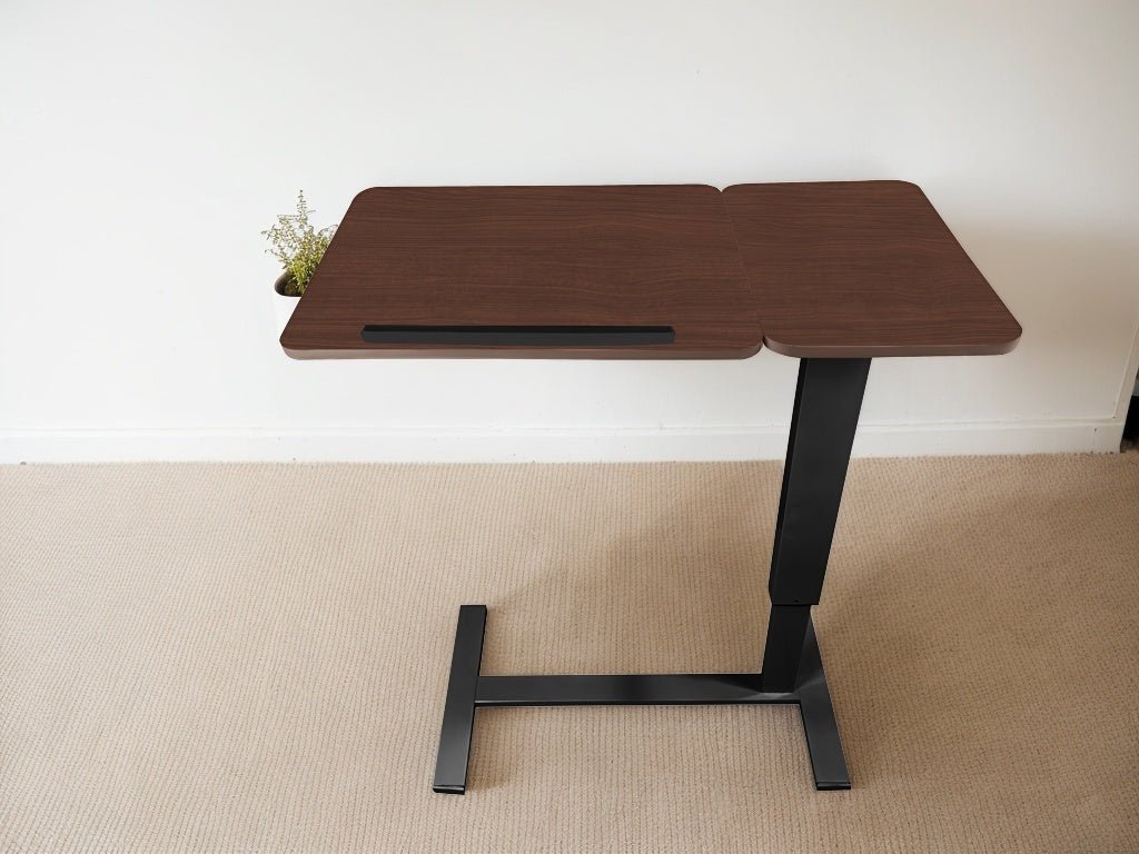 Walnut folding overbed table by Anthony & Home with a sleek wooden surface and sturdy metal legs, designed for versatile bedside use.