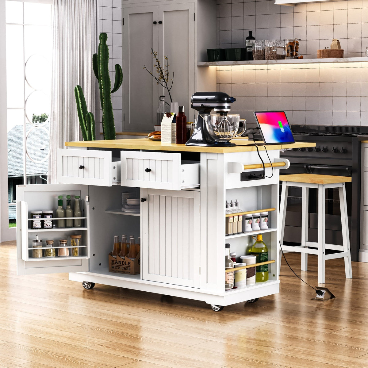 White kitchen island from the Atelier Collection by Anthony & Home, featuring a spacious surface and storage drawers.