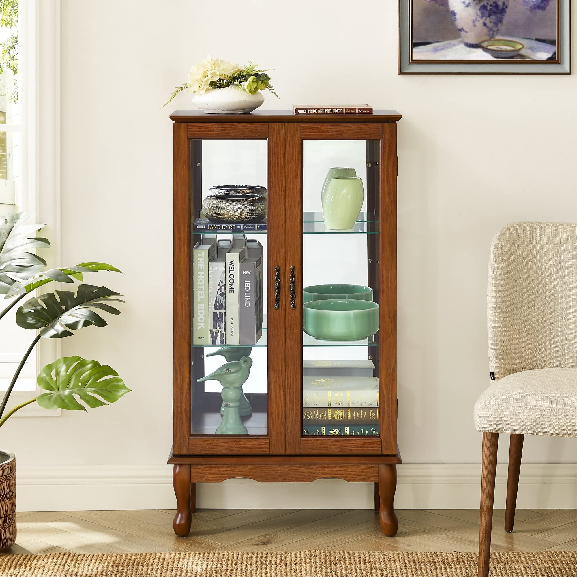 Oak finish lighted curio cabinet with mirrored back by Anthony & Home, showcasing glass shelves and elegant display space.