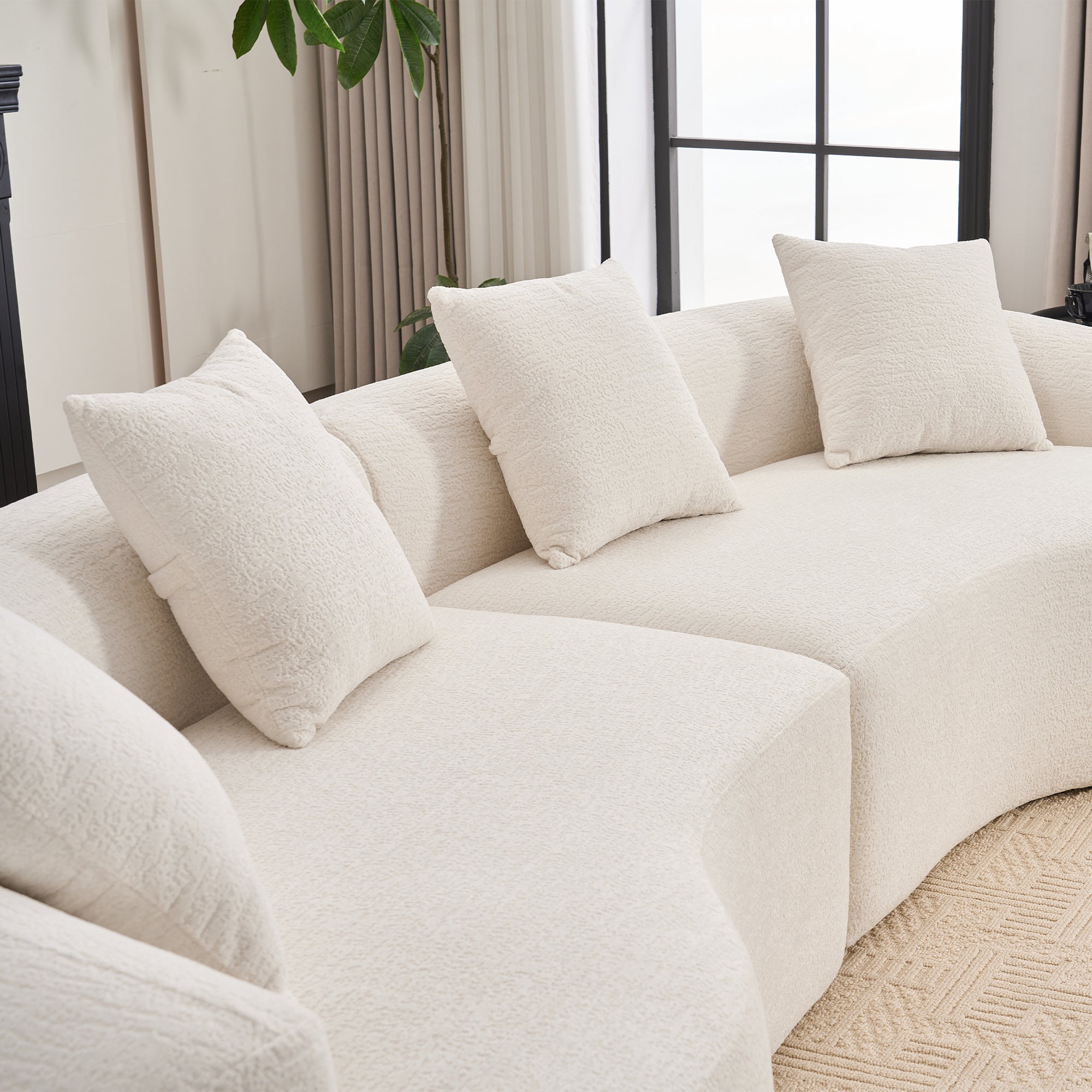 Chenille Luxe Signature curved modular sofa in cloud white upholstery from Anthony & Home Studio Collection.