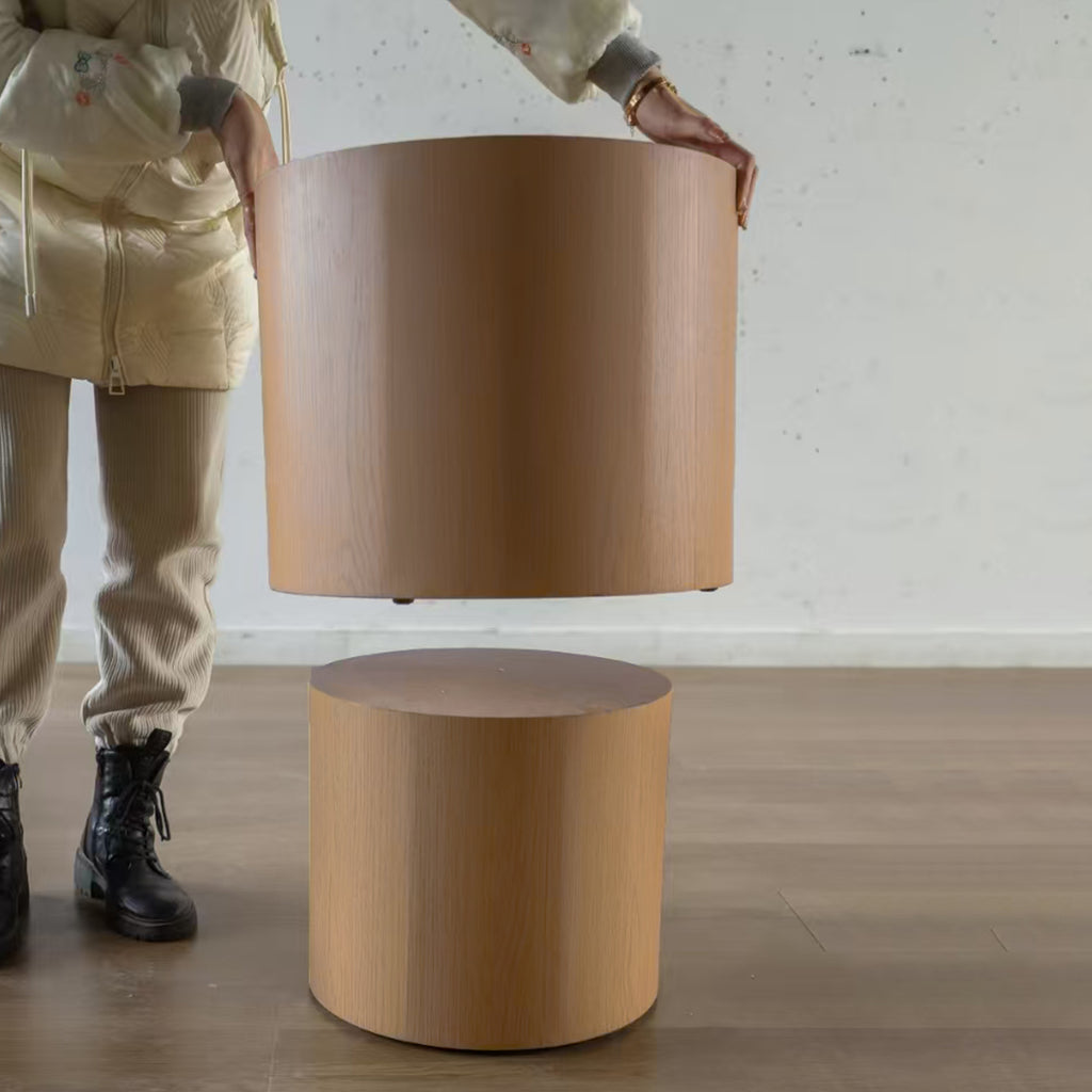 Pair of nesting round coffee tables in wood with black metal legs from Anthony & Home's Atelier collection.