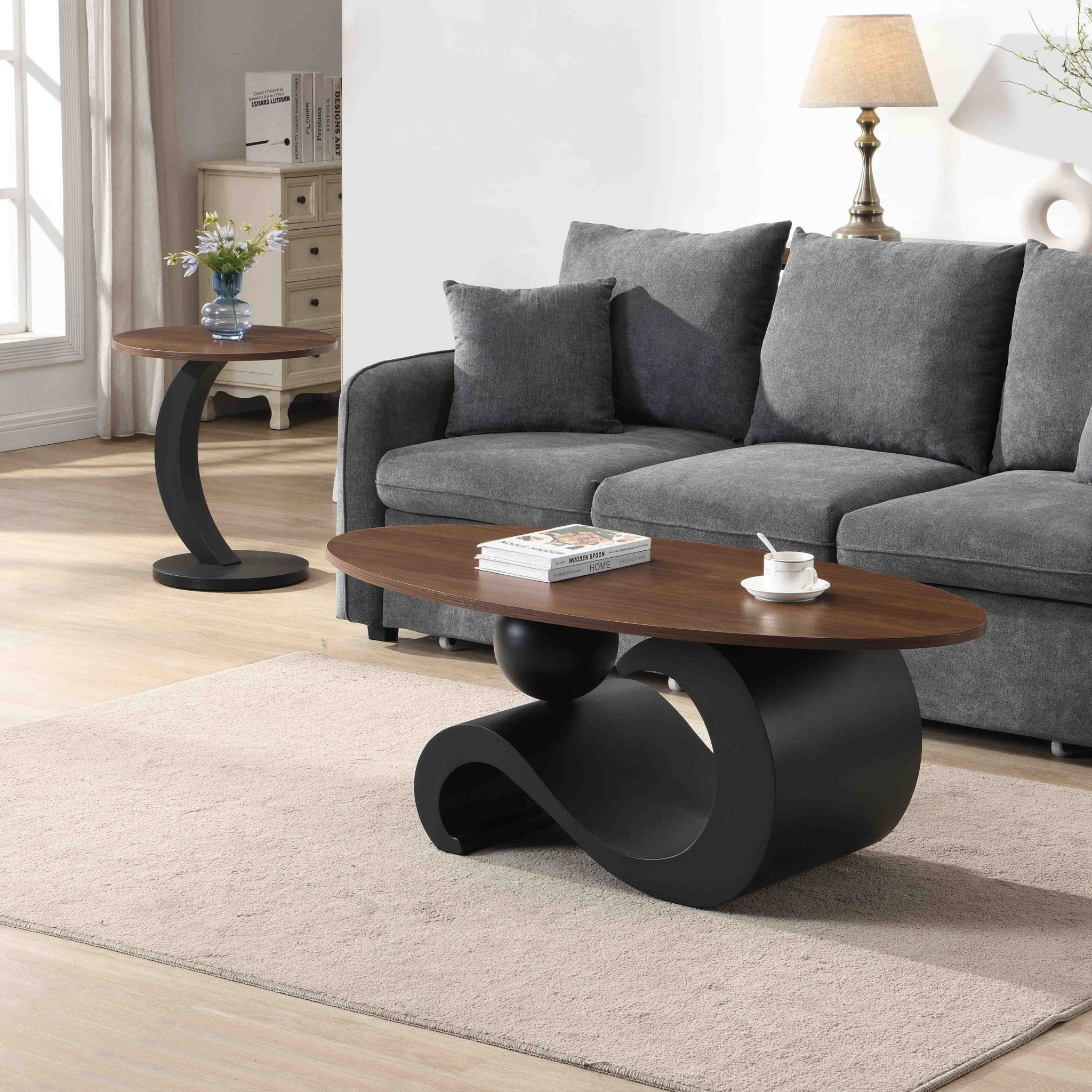 Set of black MDF nesting coffee tables with metal bases by Anthony & Home, shown stacked together on a neutral background.