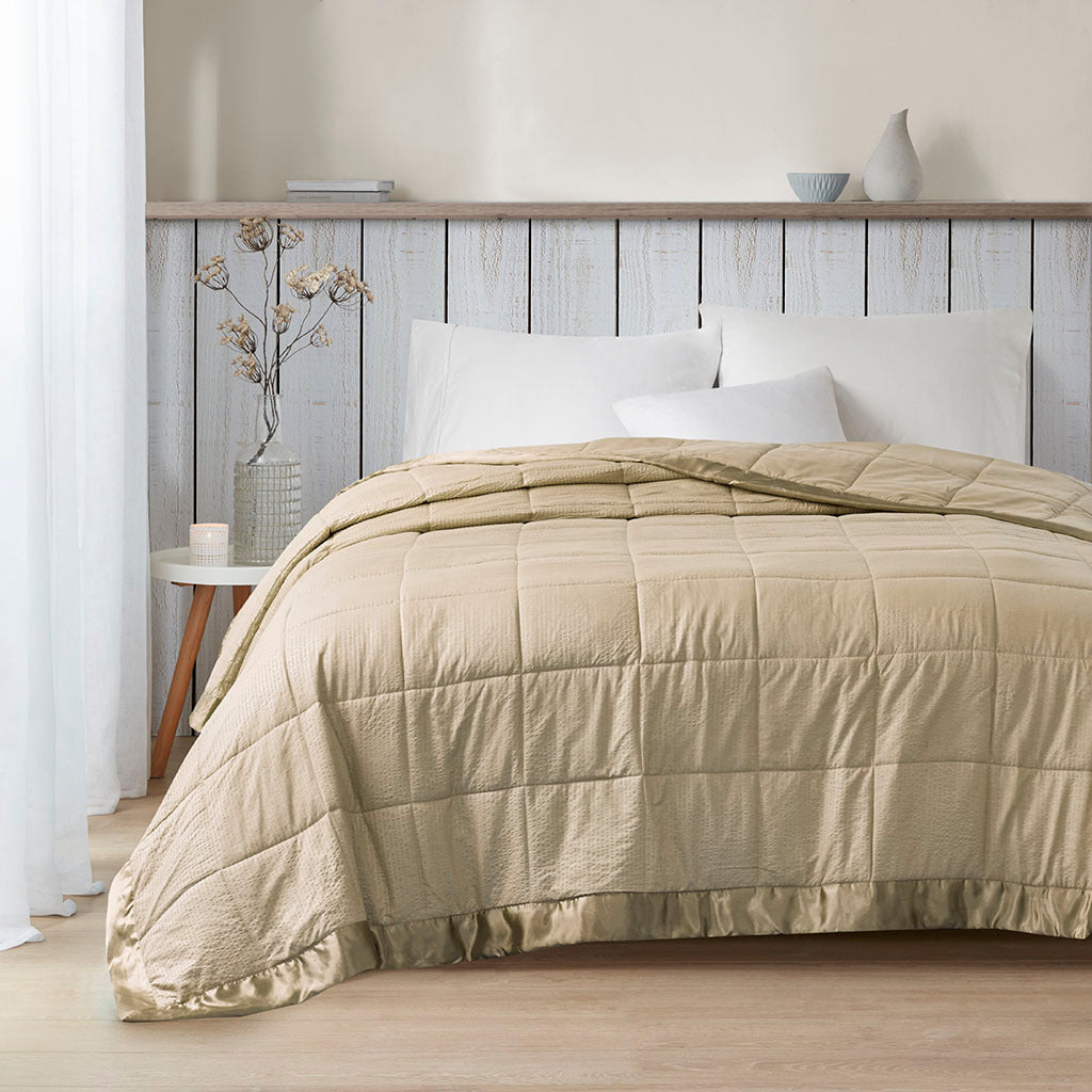 Taupe satin-trim oversized king blanket by Anthony & Home draped for display, showing soft fabric and elegant design.