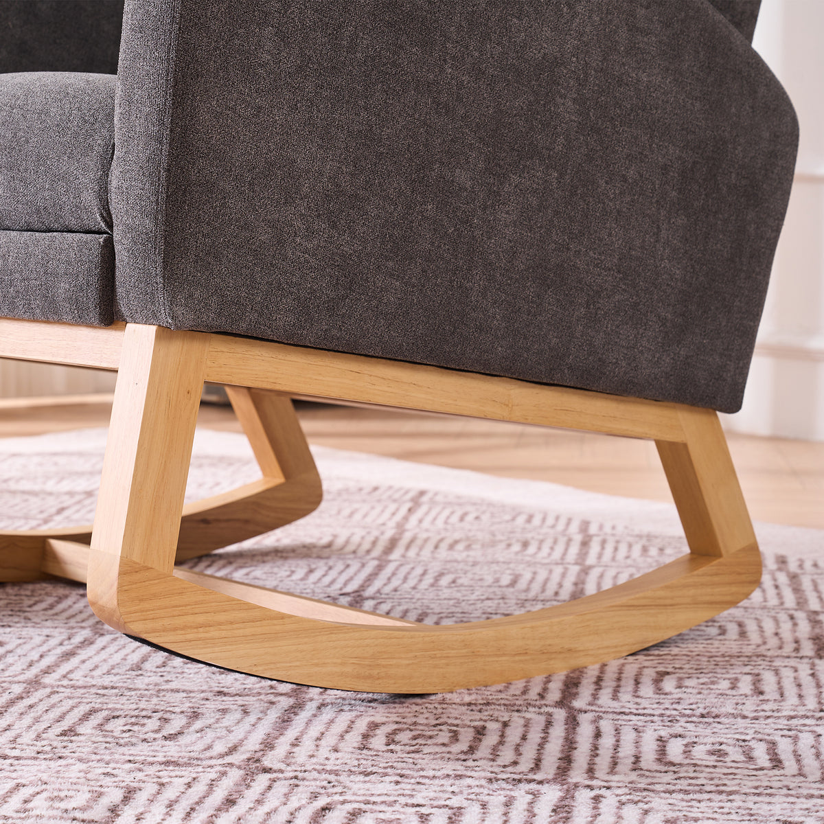 Gray rocking chair with footrest and rubber wood frame, designed for studio use by Anthony & Home.