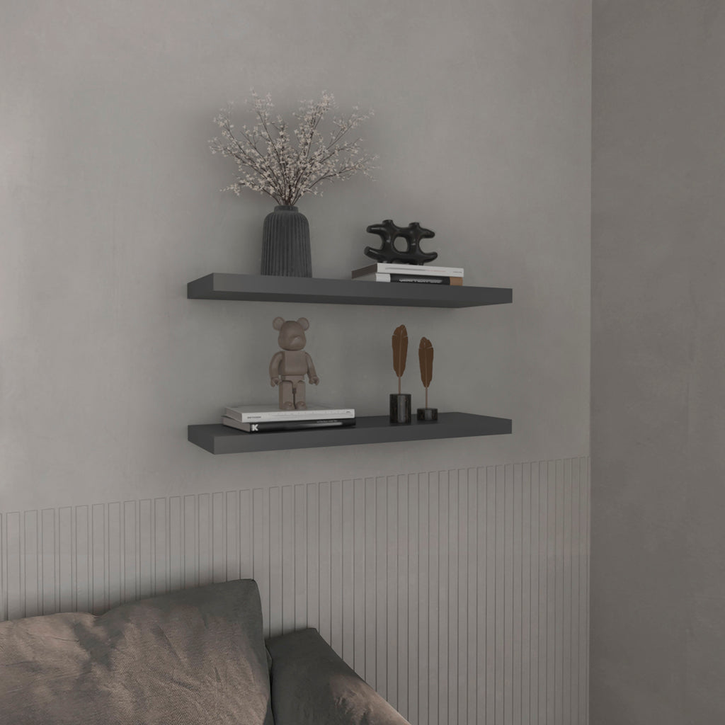 Anthony & Home Studio two-tier floating shelves in matte gray finish mounted on wall with decorative items.