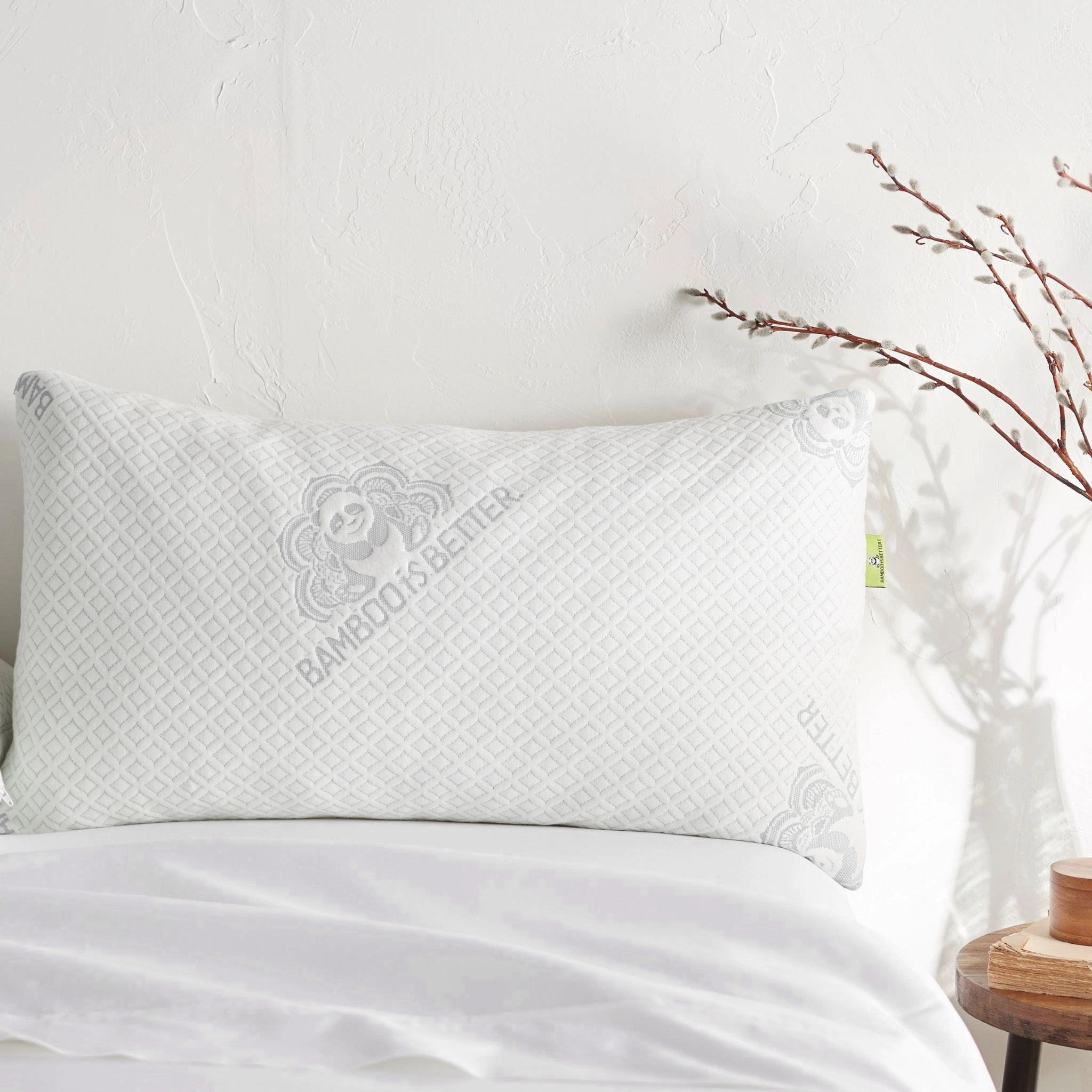 Adjustable bamboo cooling pillow from Bamboo is Better, showing a white bed pillow with adjustable features on a bed.