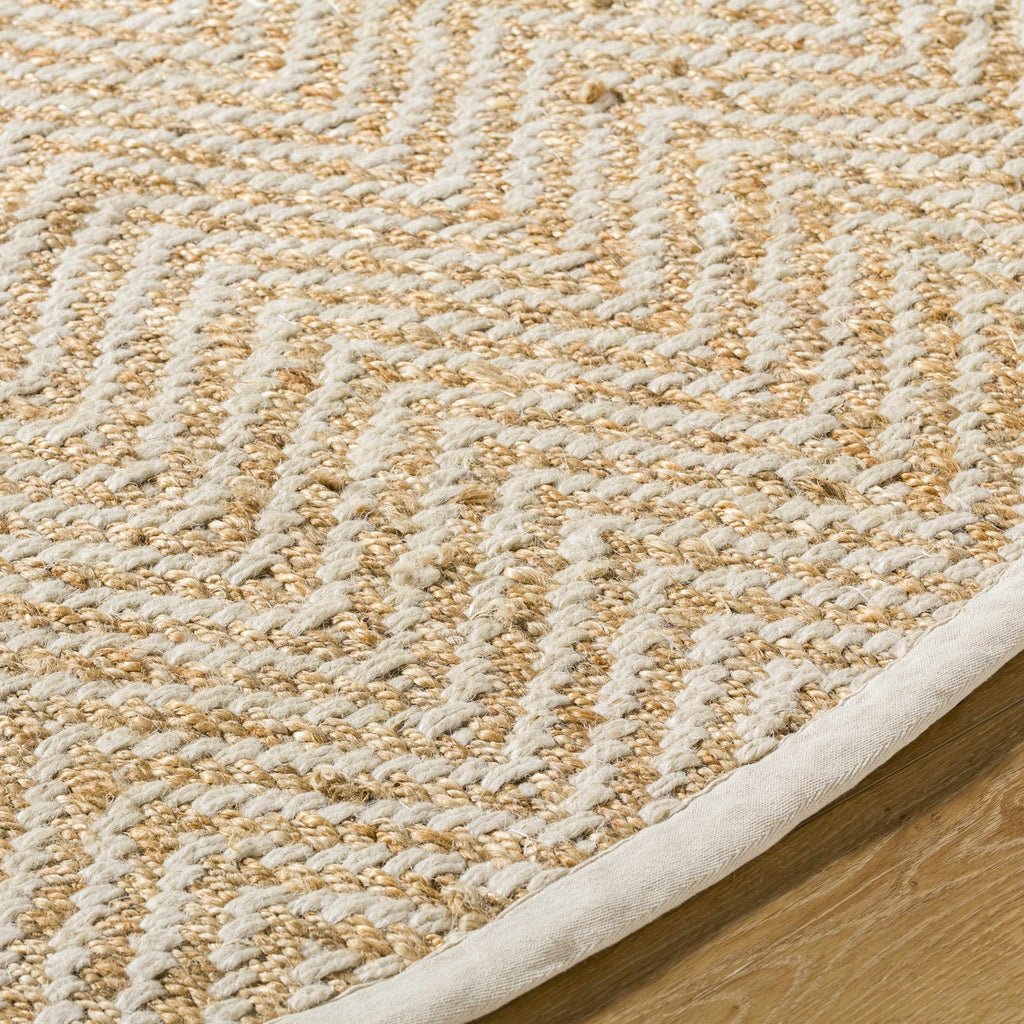 Round Aren Hand Woven Jute Area Rug by Boutique Rugs featuring natural textured jute fibers and intricate weaving.