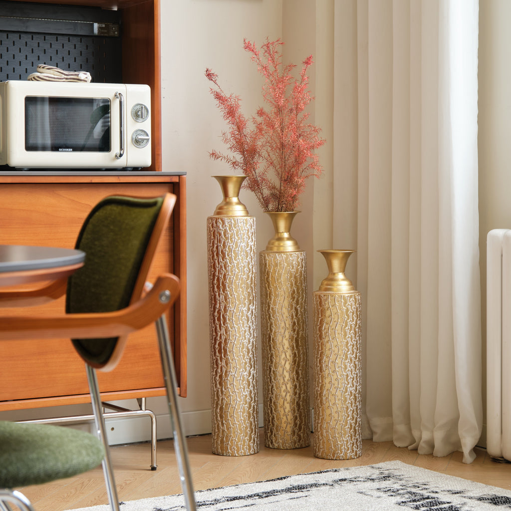 Set of three Heritage Collection gold distressed metal vases with vine pattern, ideal for living room decor by Anthony & Home