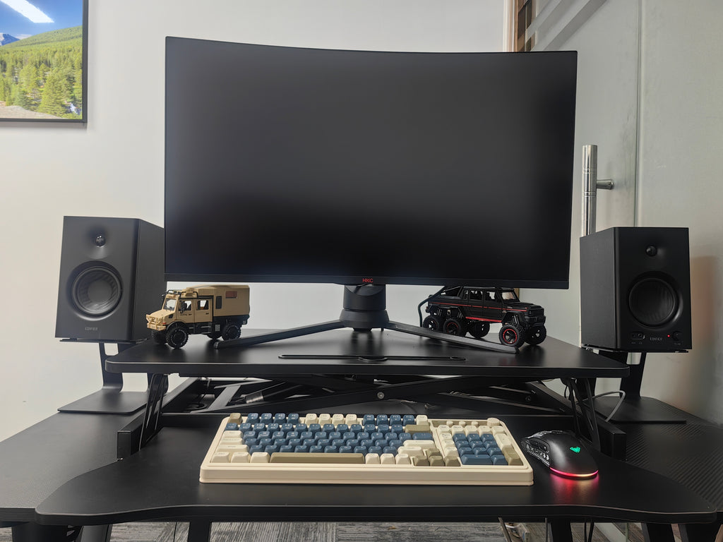 Aluminum 32-inch desk converter with dual monitor tray, adjustable height and spacious workspace for ergonomic office setup.