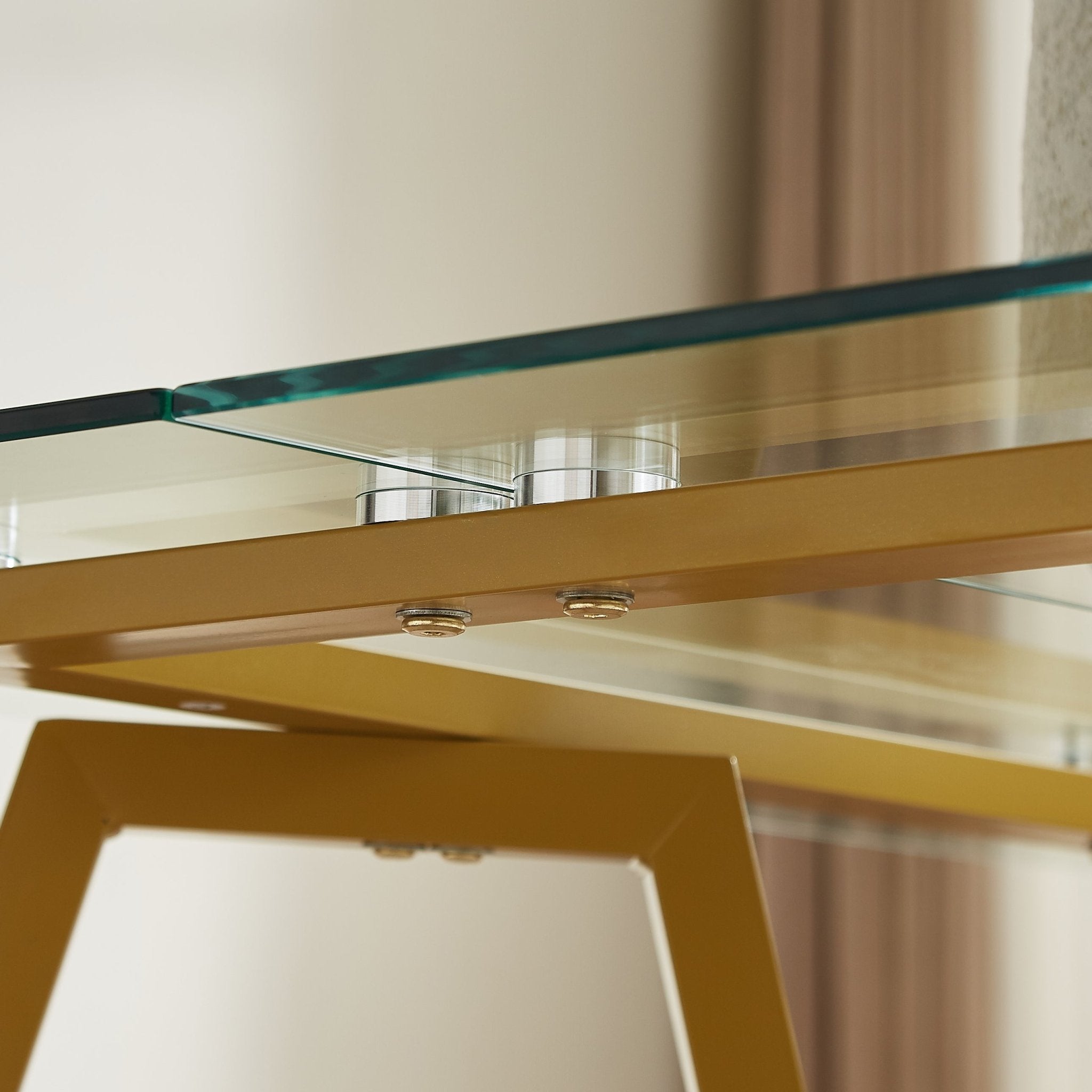 Rectangular glass dining table with gold finish from the Atelier Collection by Anthony & Home, showcasing a modern and elegant design.