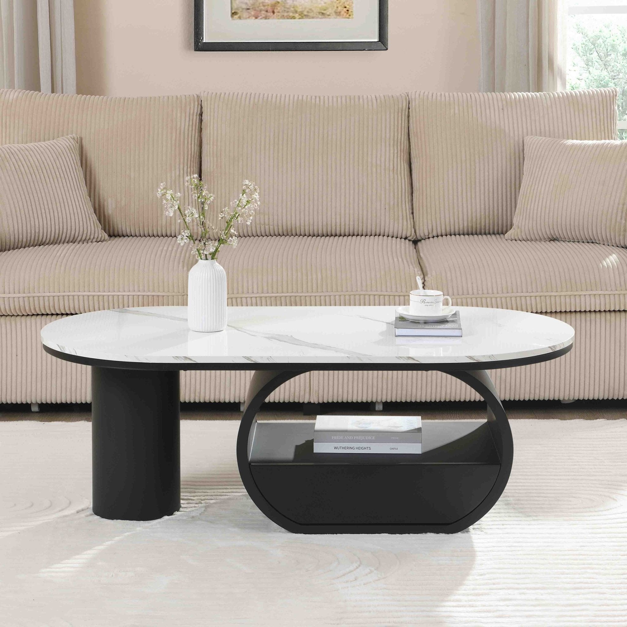 Oval coffee table with faux marble top and black metal frame, modern studio style from Anthony & Home