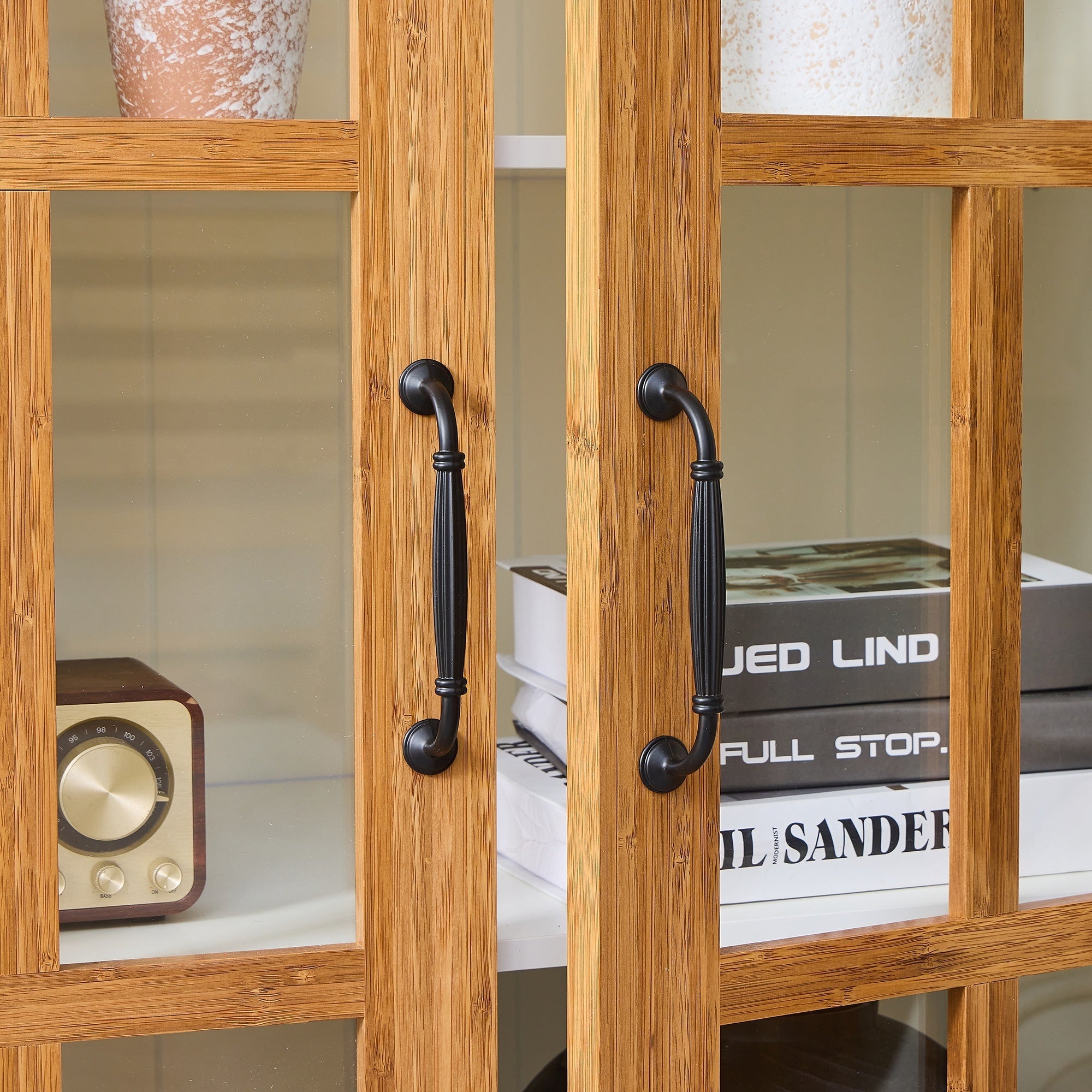 Anthony & Home Atelier Rustic Display Cabinet with glass doors and bamboo accents, showcasing its natural wood finish and interior shelving.