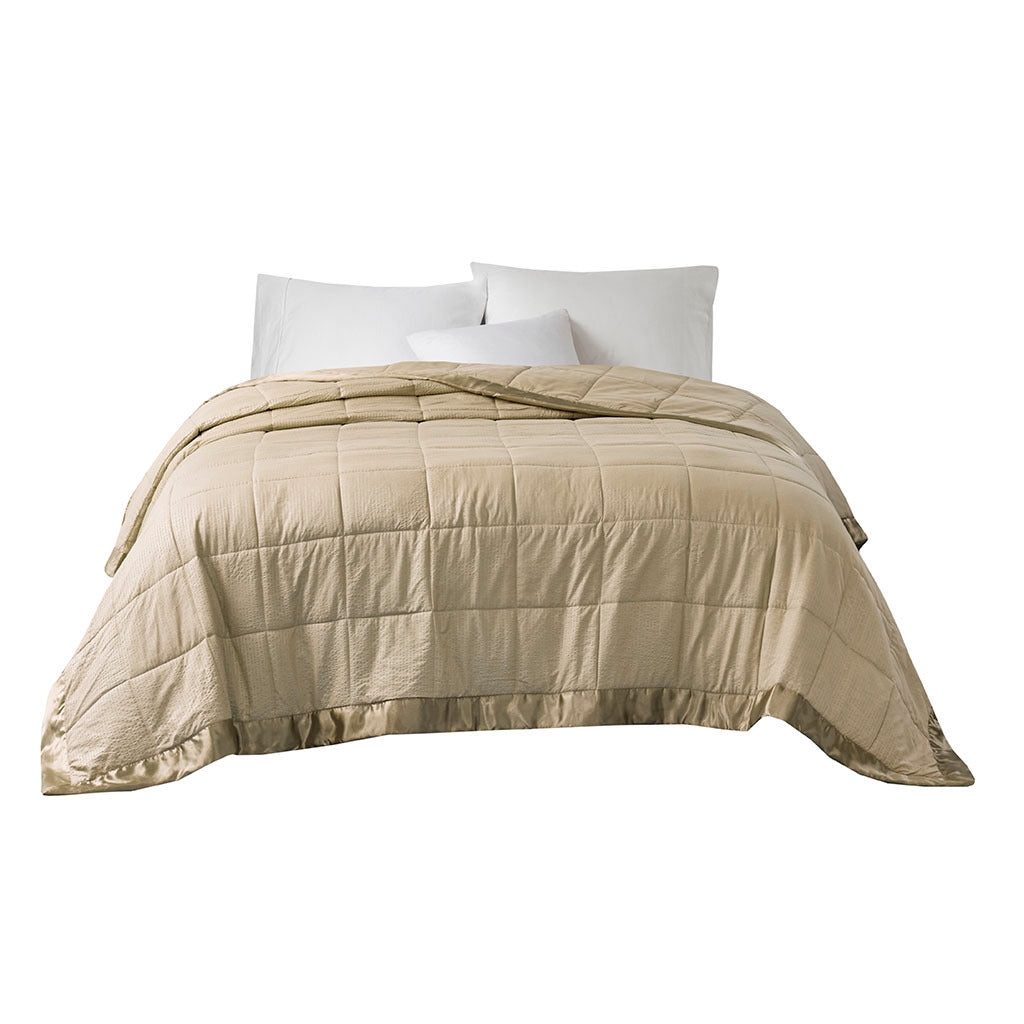 Taupe satin-trim oversized king blanket by Anthony & Home draped on a bed, showcasing its luxurious fabric and cozy design.