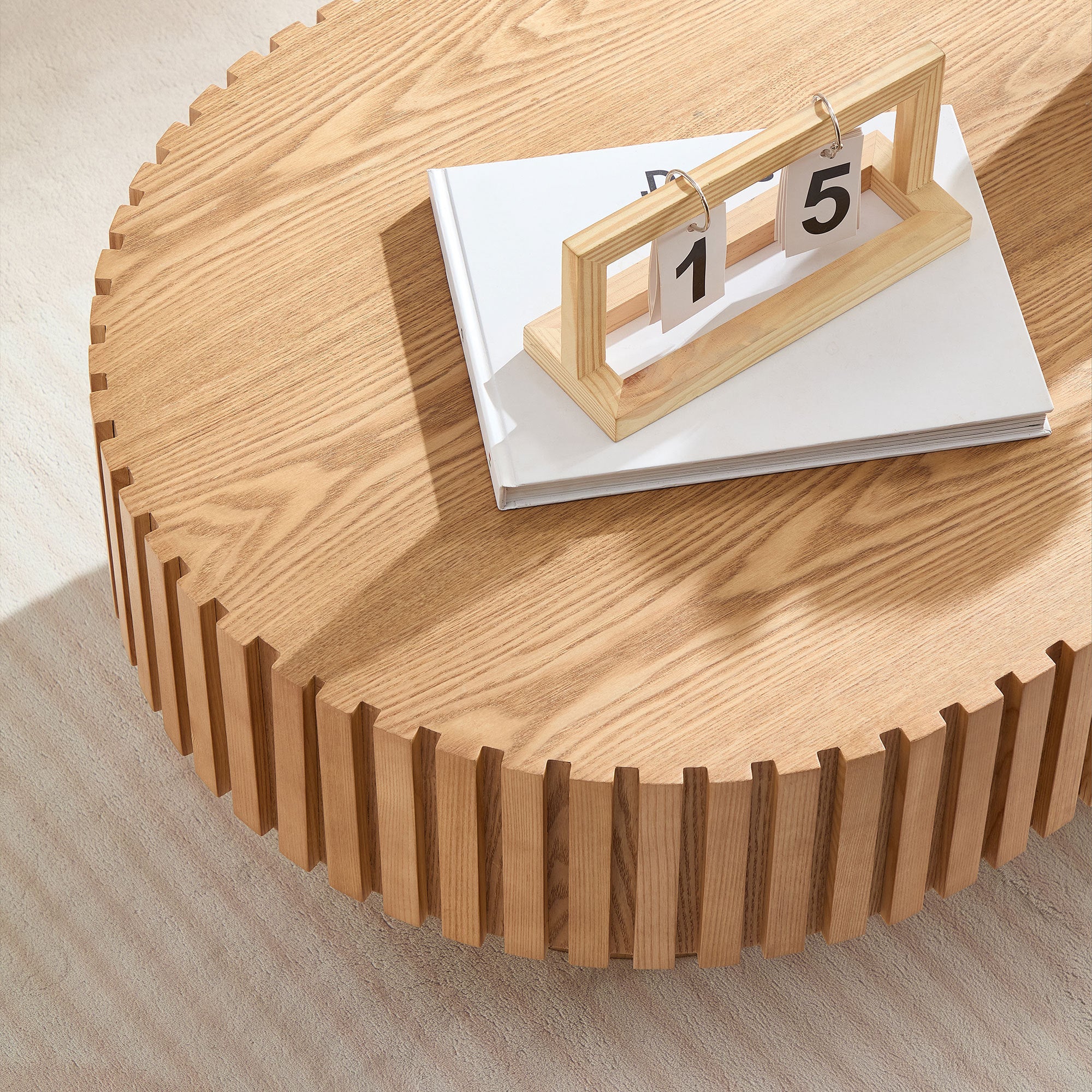 Oval drum coffee table by Anthony & Home in ash finish, 43.7 inches wide, showcasing smooth wood surface and modern design.