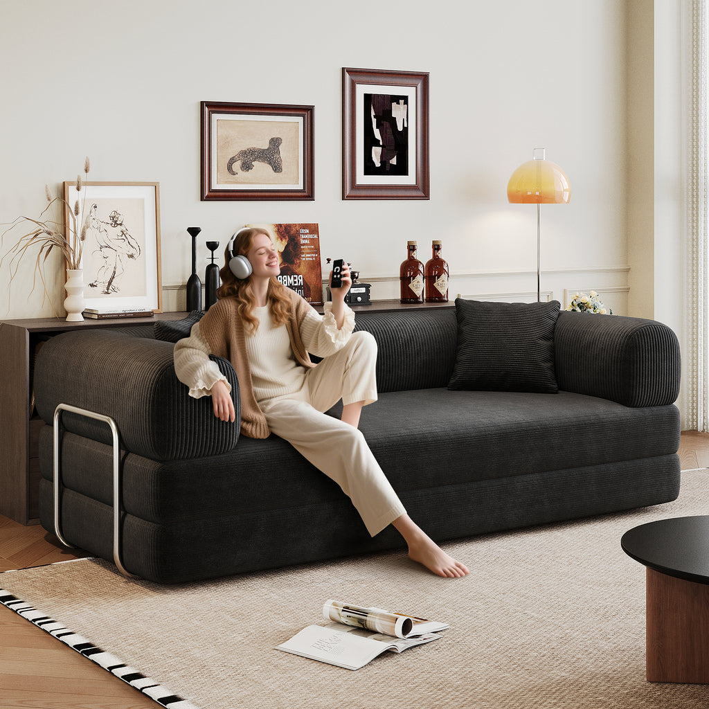 Black corduroy convertible sofa bed from Anthony & Home's Atelier Collection, showing the sofa in both sitting and bed configurations.