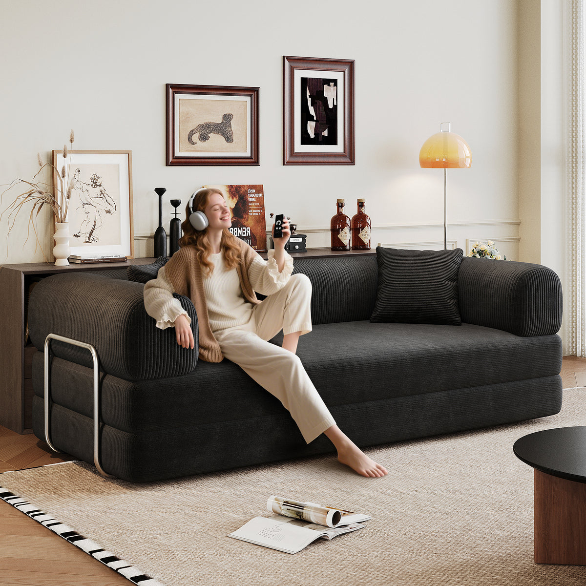Black corduroy convertible sofa bed from Anthony & Home's Atelier Collection, showing the sofa in both sitting and bed configurations.