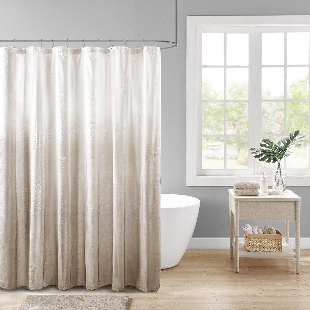 Ombre taupe seersucker shower curtain from Anthony & Home with textured fabric and subtle color gradient.