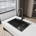 Handmade black stainless steel kitchen sink overmount by Anthony & Home, showcasing durable, sleek design with smooth edges.