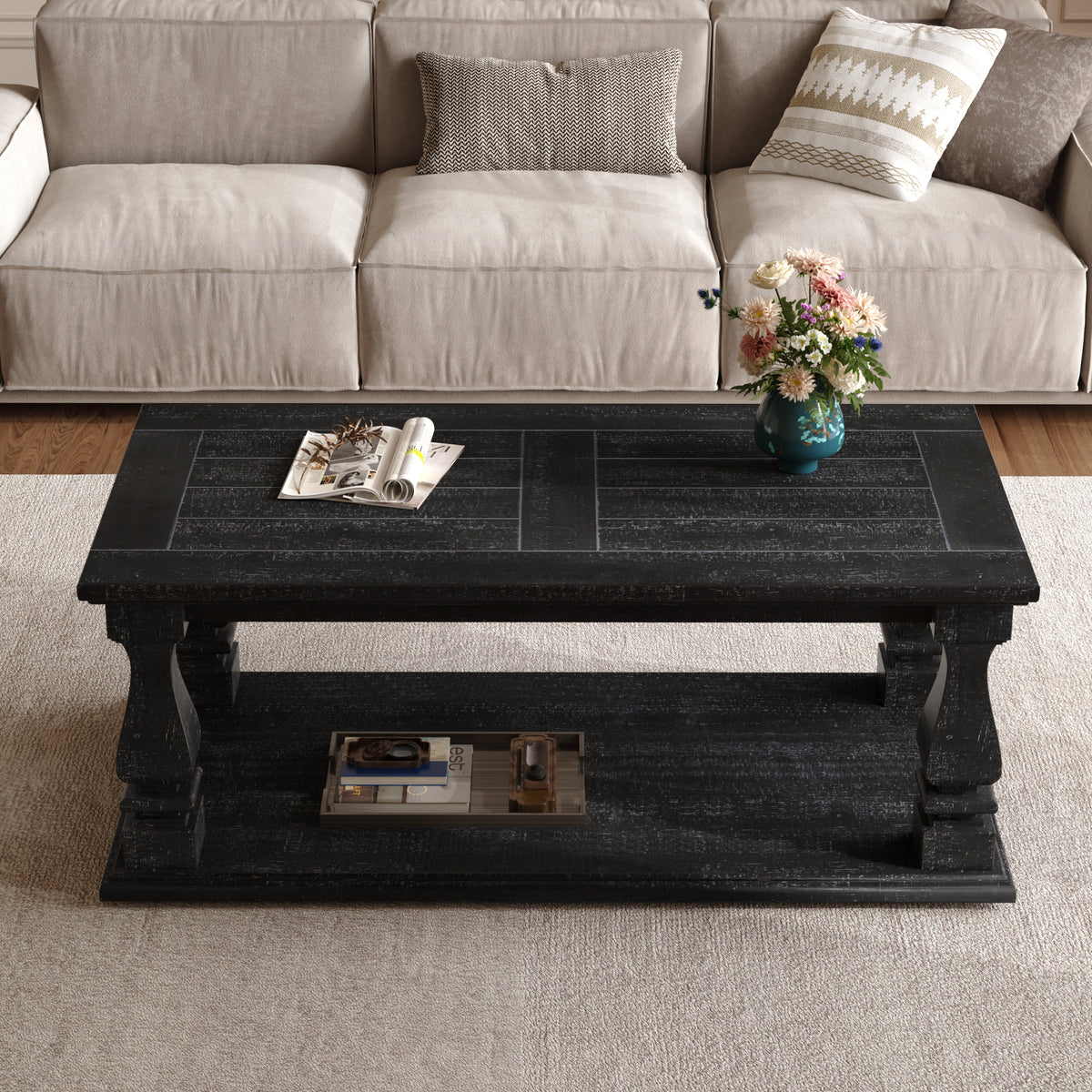 Weathered black farmhouse coffee table with heavy plank top, baluster legs, and storage shelf from Anthony & Home's Atelier Collection.