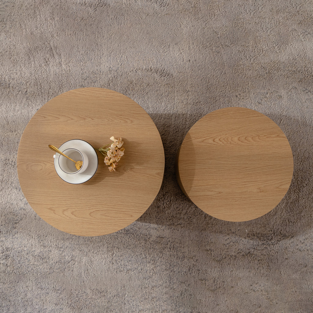 Set of nesting round coffee tables by Anthony & Home, featuring sleek wooden surfaces and modern design.