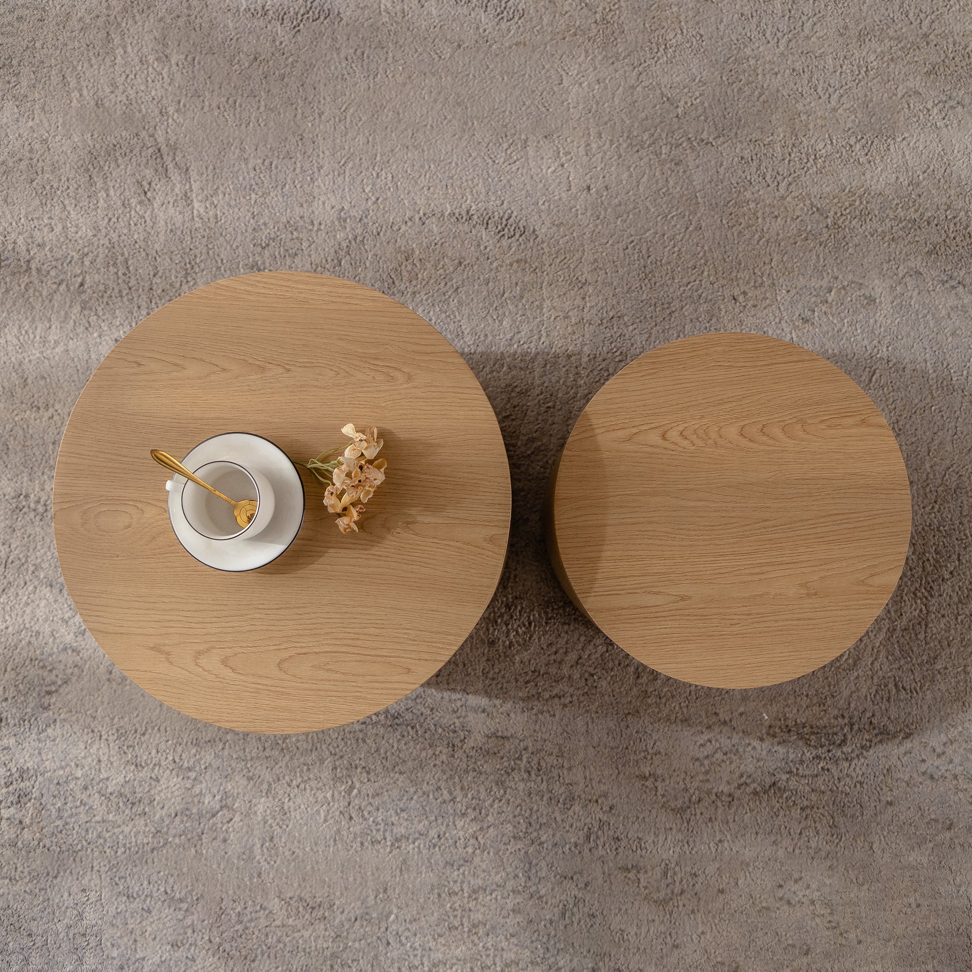 Set of nesting round coffee tables by Anthony & Home, featuring sleek wooden surfaces and modern design.