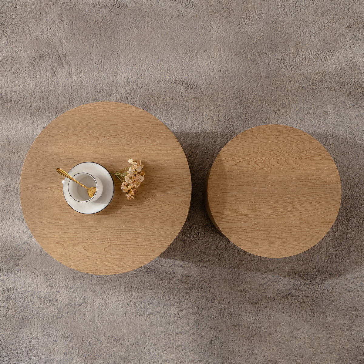 Set of nesting round coffee tables by Anthony & Home, featuring sleek wooden surfaces and modern design.