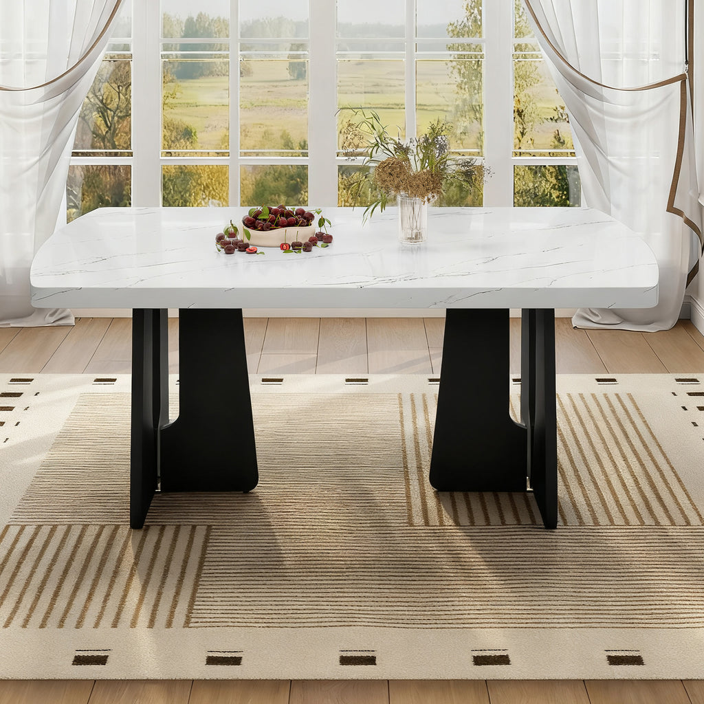 Black and white faux marble dining table with geometric black legs by Anthony & Home
