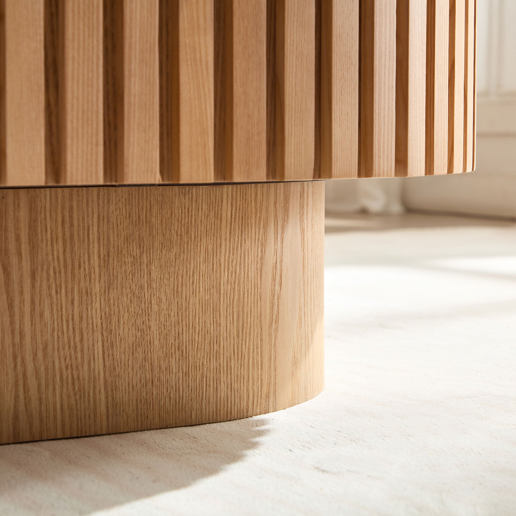 Oval drum coffee table in ash finish by Anthony & Home, showing its smooth surface and contemporary design.