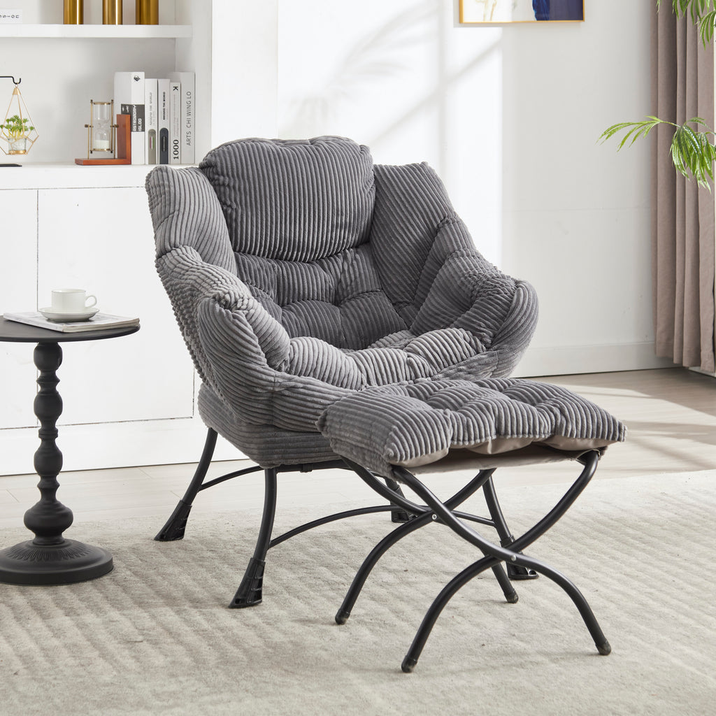 Grey upholstered lounge chair with matching ottoman and armrests, modern design by Anthony & Home.