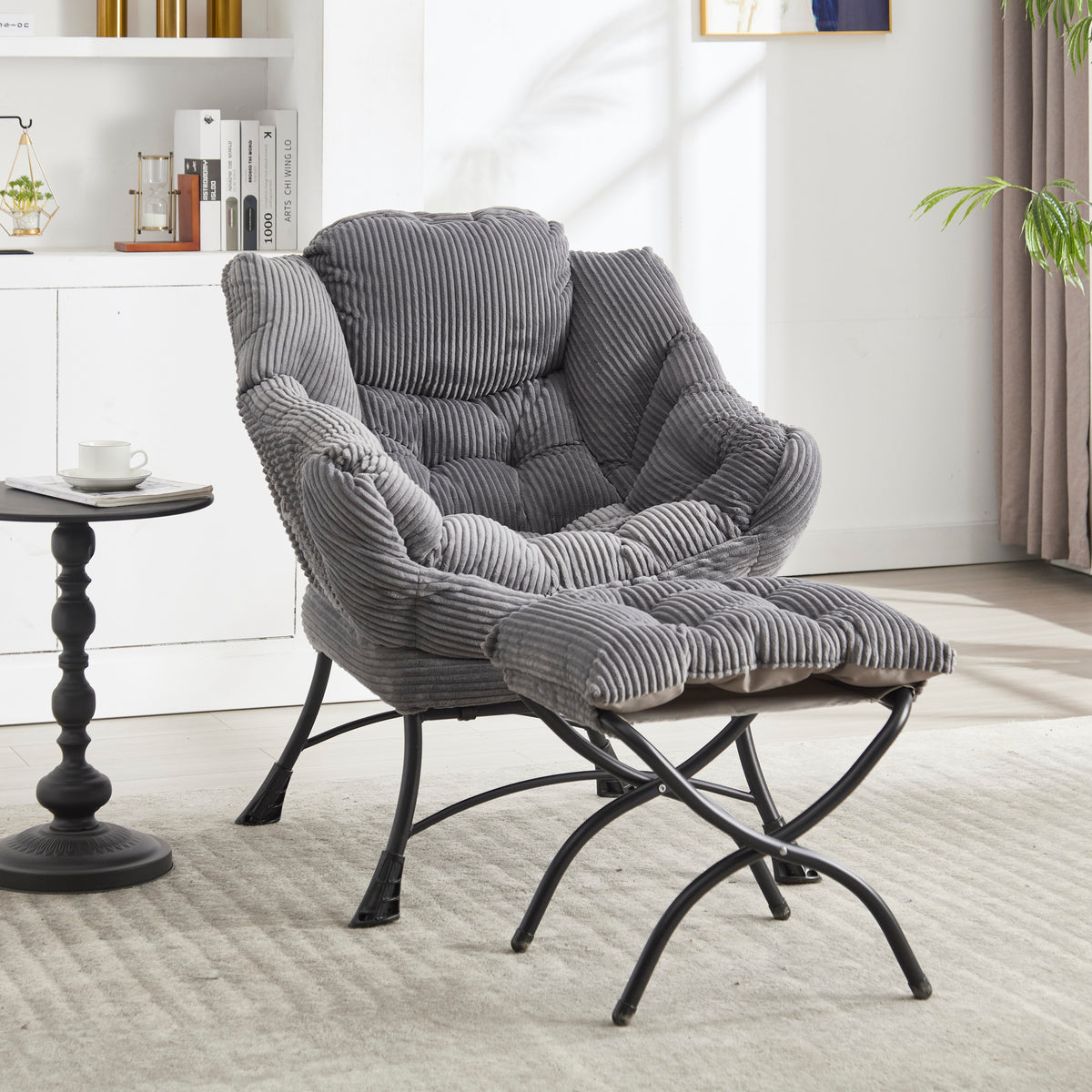 Grey upholstered lounge chair with matching ottoman and armrests, modern design by Anthony & Home.