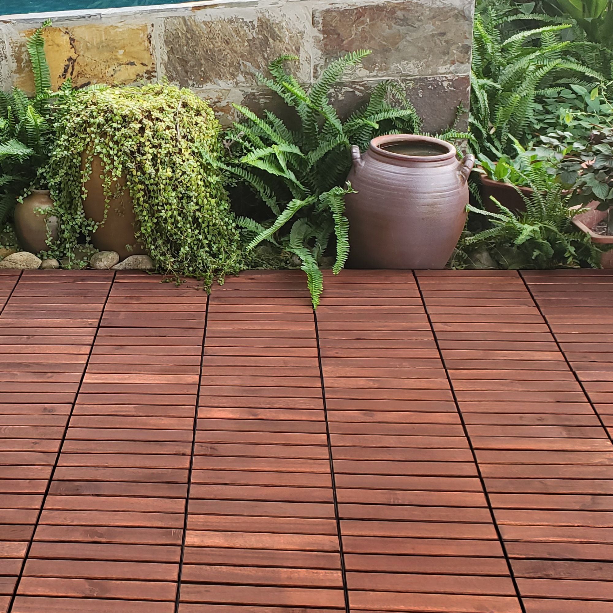 Anthony & Home Acacia Studio Interlocking Deck Tiles with striped design, 12-inch square outdoor flooring for patios and decks.