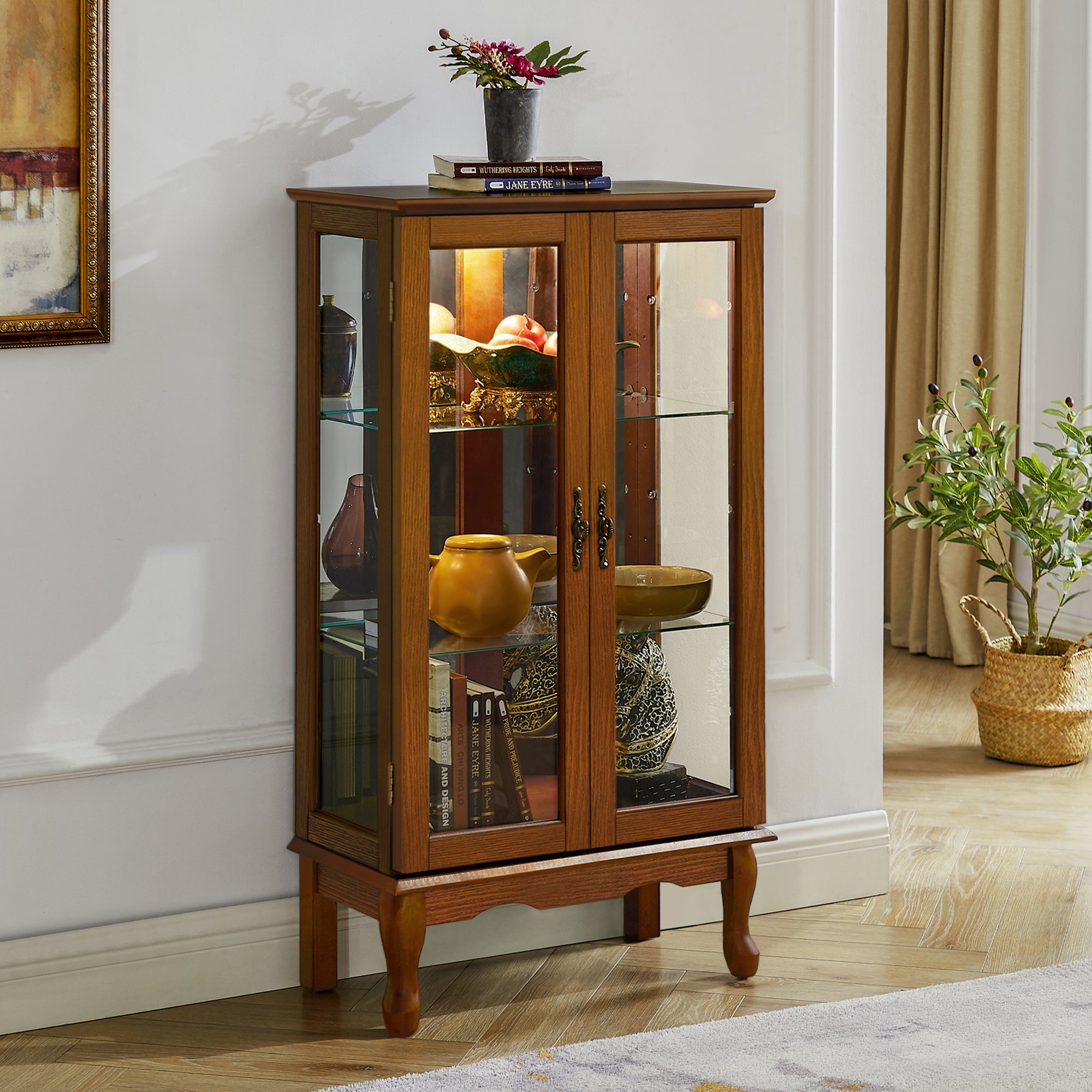 Oak finish lighted curio cabinet with mirrored back, showcasing glass shelves and elegant heritage design by Anthony & Home.