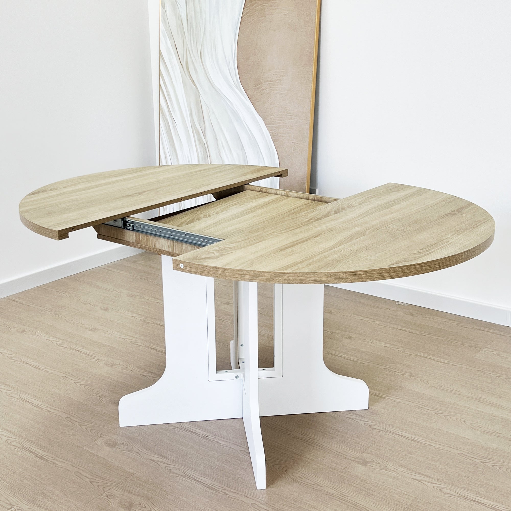 White Oak Edition oval dining table with expandable leaf by Anthony & Home, showing its polished wood surface and elegant design.