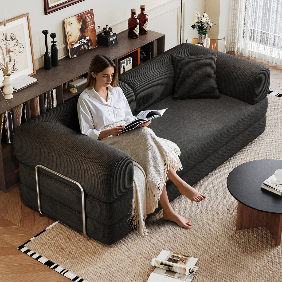 Black corduroy convertible sofa bed from Anthony & Home's Atelier Collection, showing the sofa in its fully extended bed position.