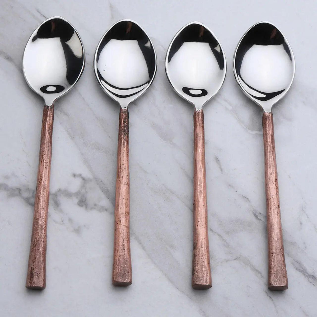 Set of four Sundance copper antique table spoons by INOX Artisans, featuring elegant vintage design for dining and serving.
