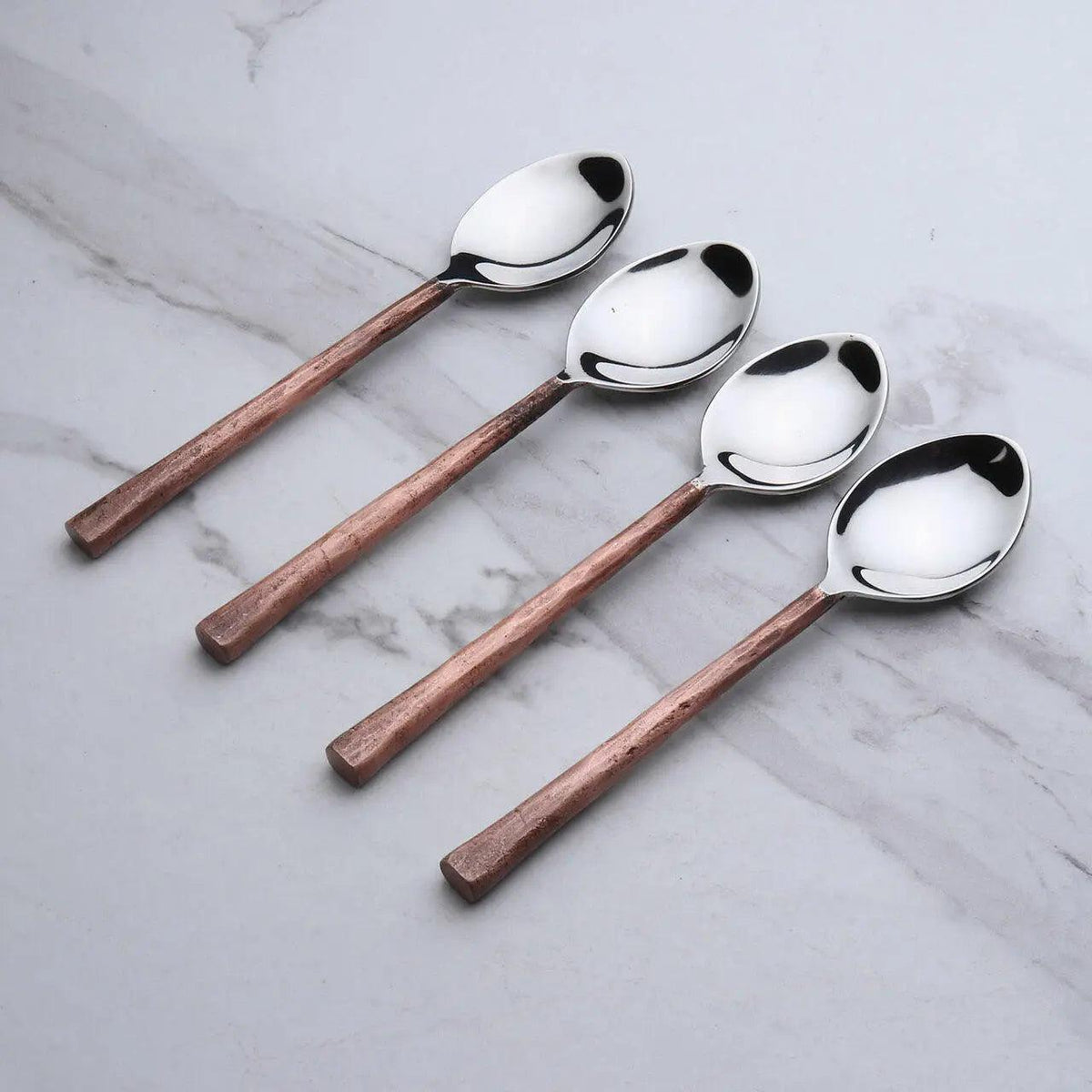Set of four Sundance copper antique table spoons by INOX Artisans, featuring elegant, vintage-style design for dining and serving.